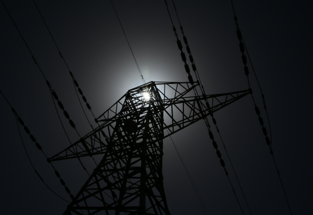 Transmission structure at night with moonlight in the background.